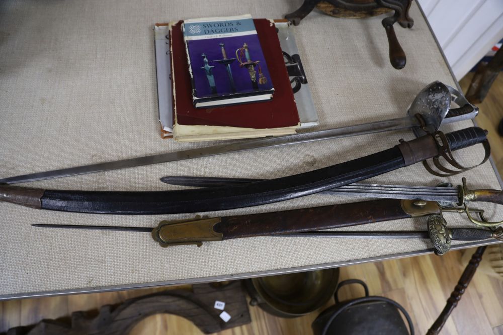 A 19th century European horn handled hunting hanger, a dress sword and three books